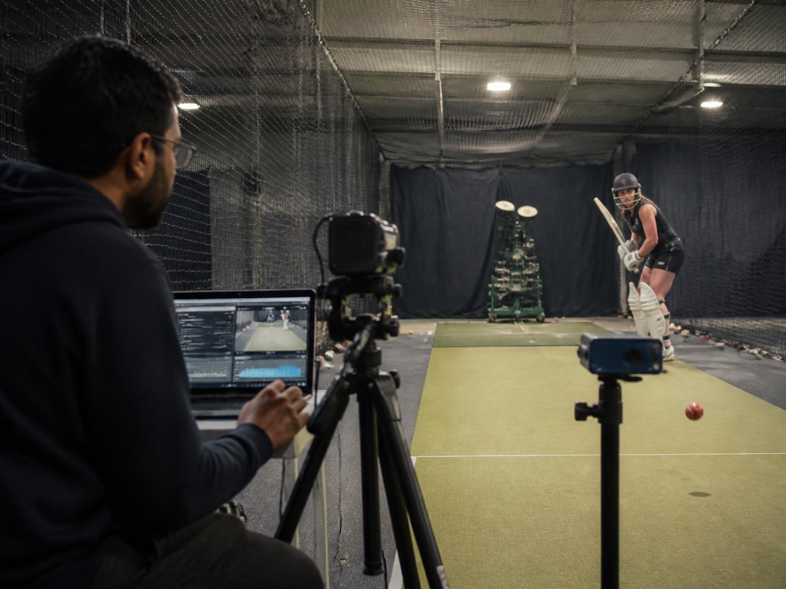 Coach and analyst reviewing footage in a video analysis bay